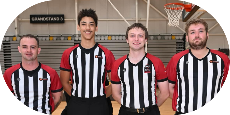 Mackay Basketball referees officiating a basketball game, diligently ensuring fair play and maintaining a competitive spirit on the court